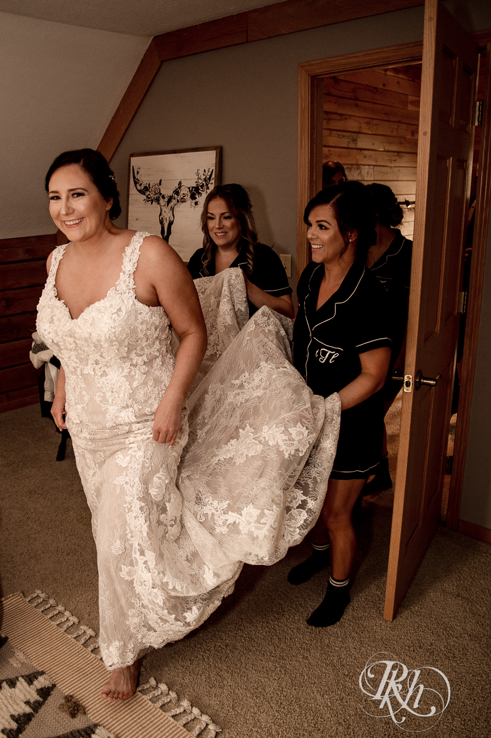 Bride laughing with her bridesmaids before the wedding at a cabin A-frame in Stillwater, Minnesota.