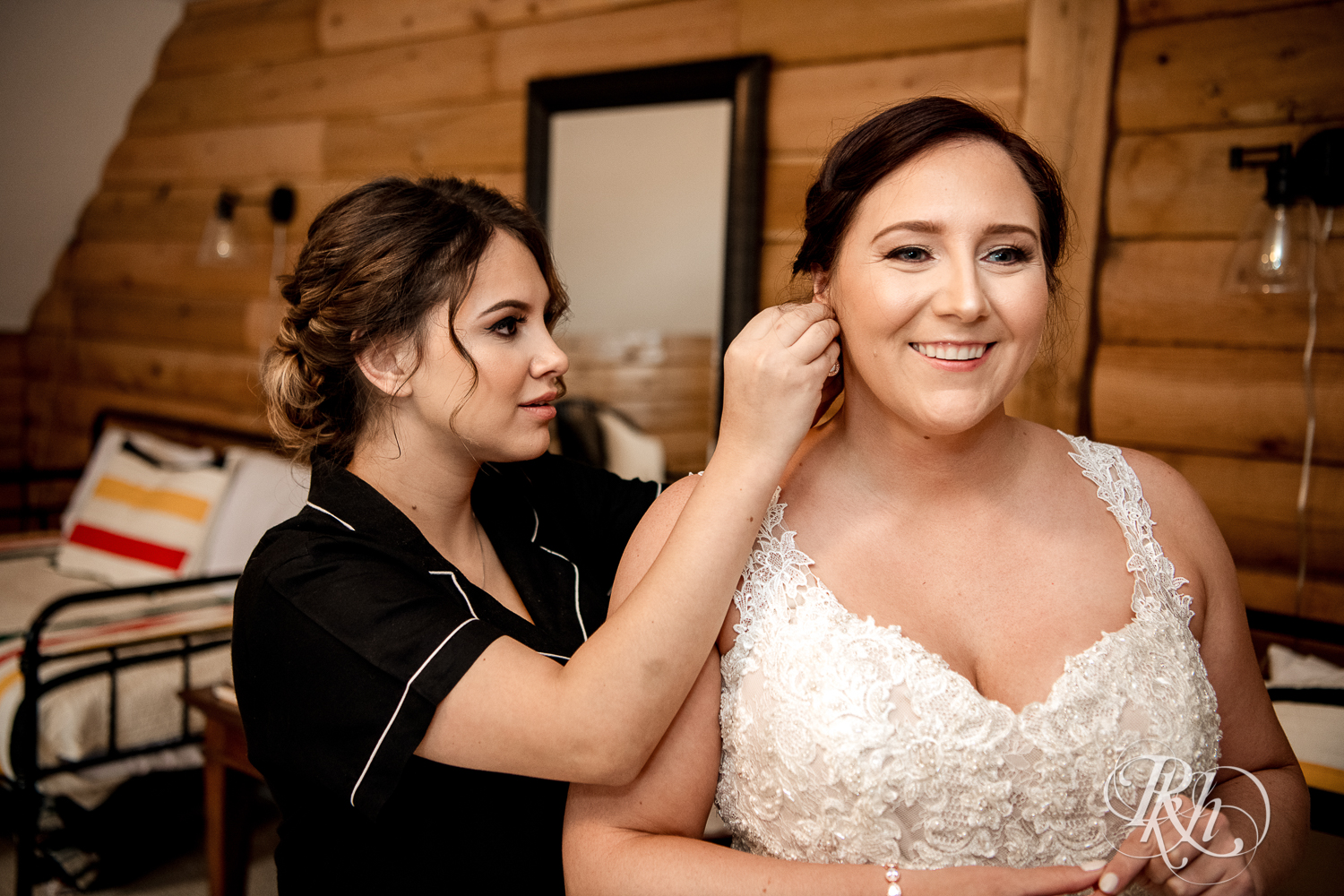 Bride putting in earring before the wedding at a cabin A-frame in Stillwater, Minnesota.
