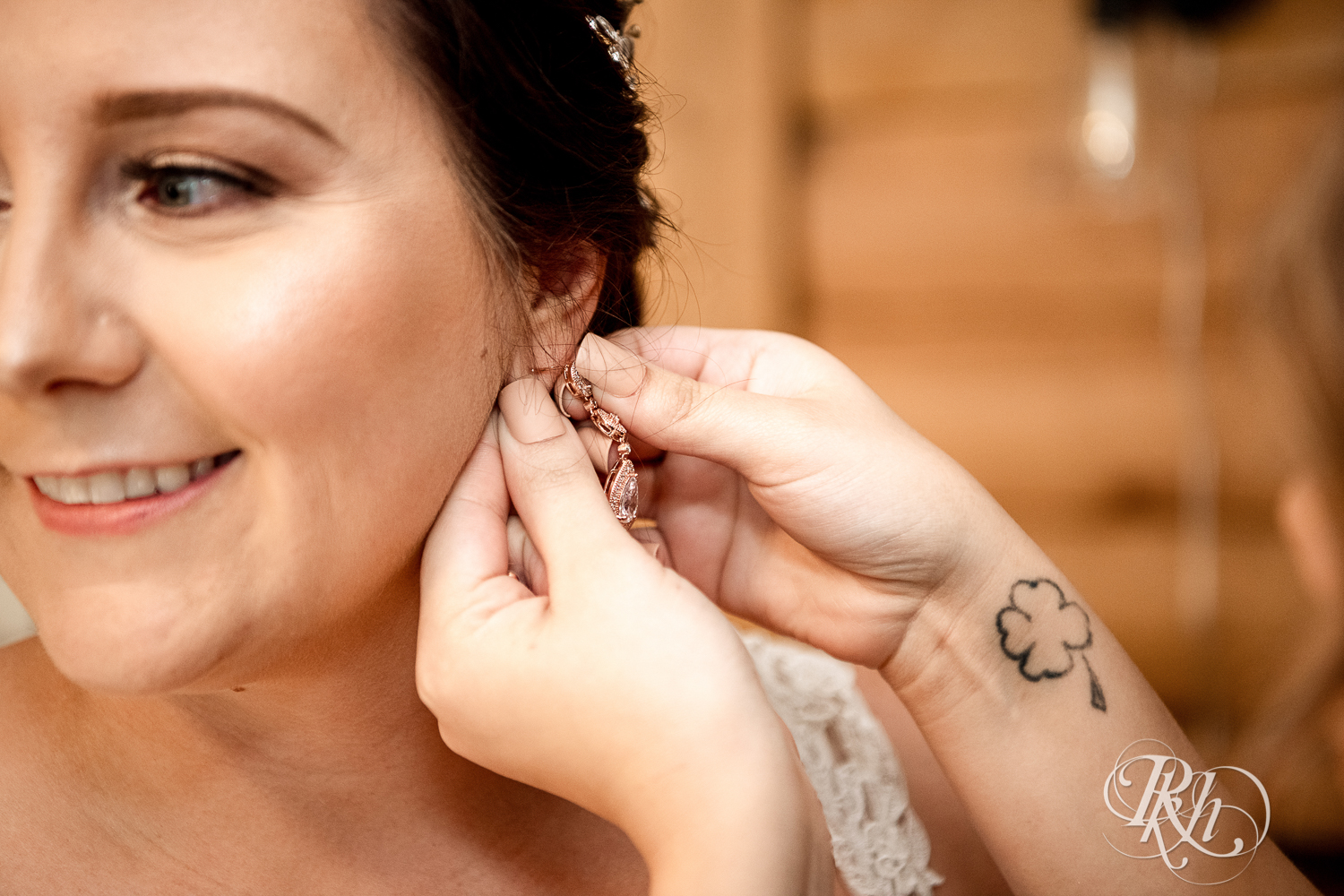 Bride putting in earring before the wedding at a cabin A-frame in Stillwater, Minnesota.