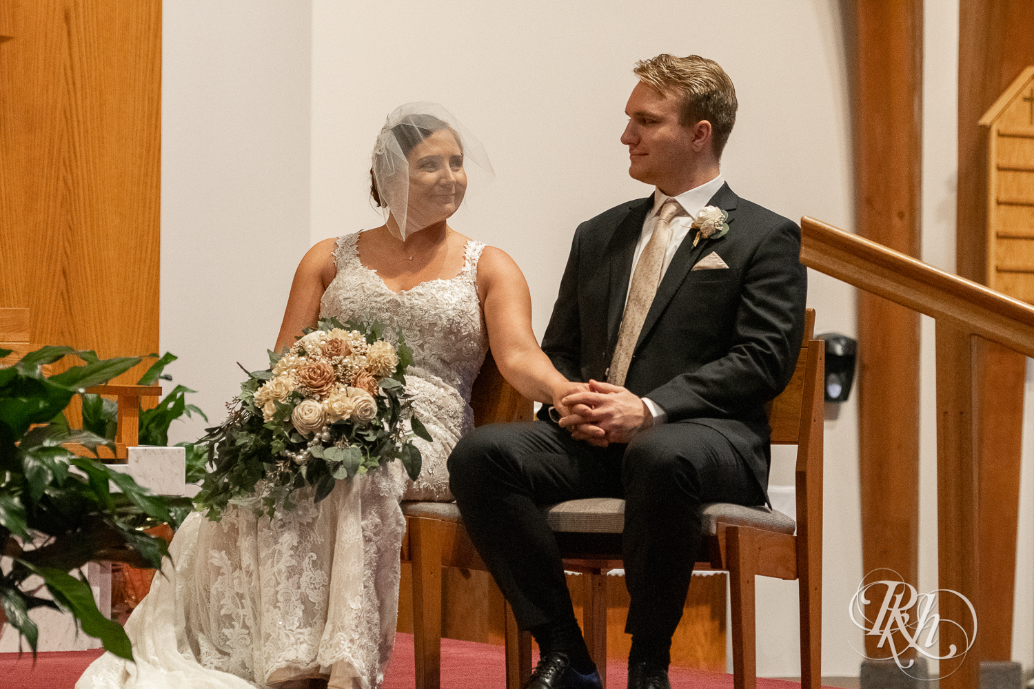 Bride and groom smile at each other at a church wedding ceremony in Stillwater, Minnesota.