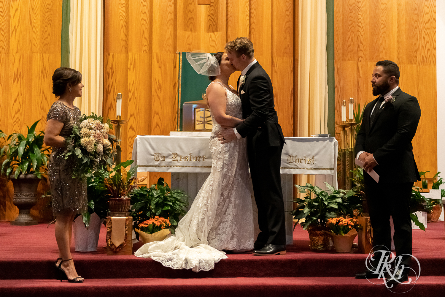 Bride and groom kiss each other at a church wedding ceremony in Stillwater, Minnesota.