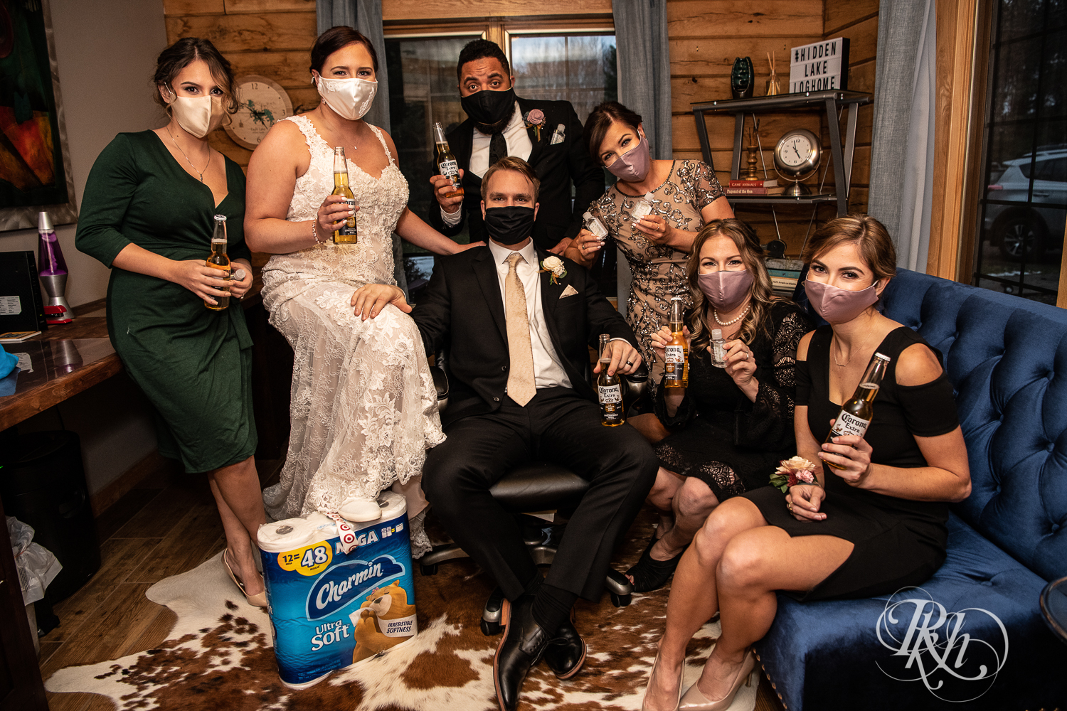 Bride and groom share Coronas and wear masks at 2020 wedding in cabin in Stillwater, Minnesota.