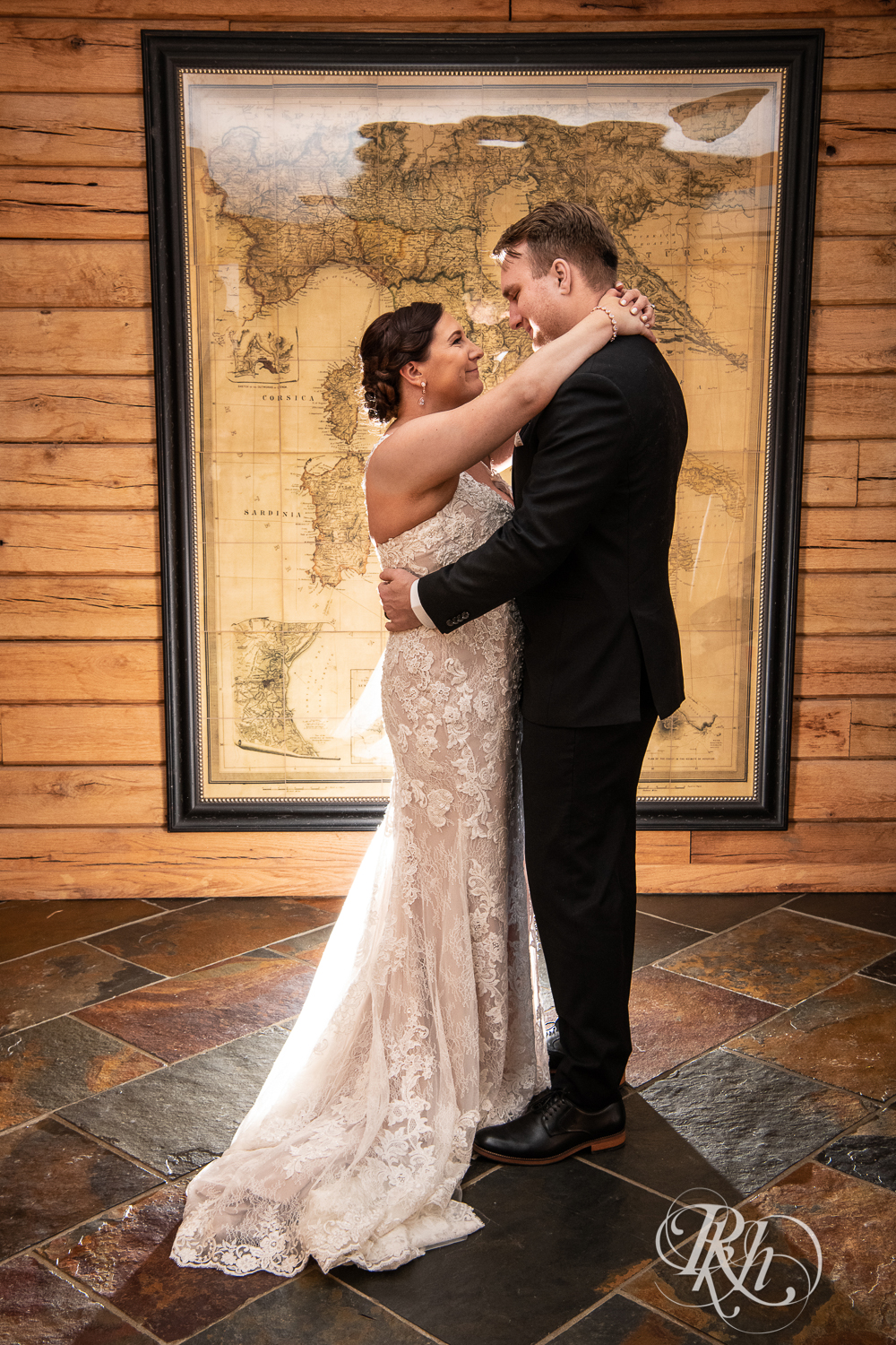 Bride and groom share first dance at wedding in cabin in Stillwater, Minnesota.