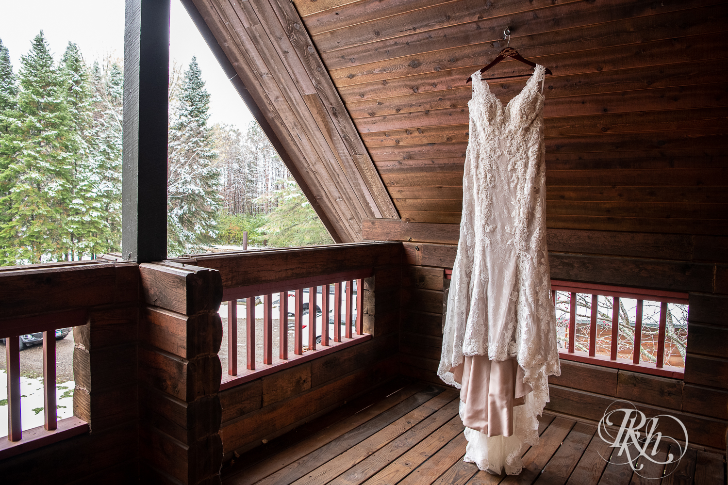 Wedding dress hanging front the ceiling of a cabin A-frame in Stillwater, Minnesota.
