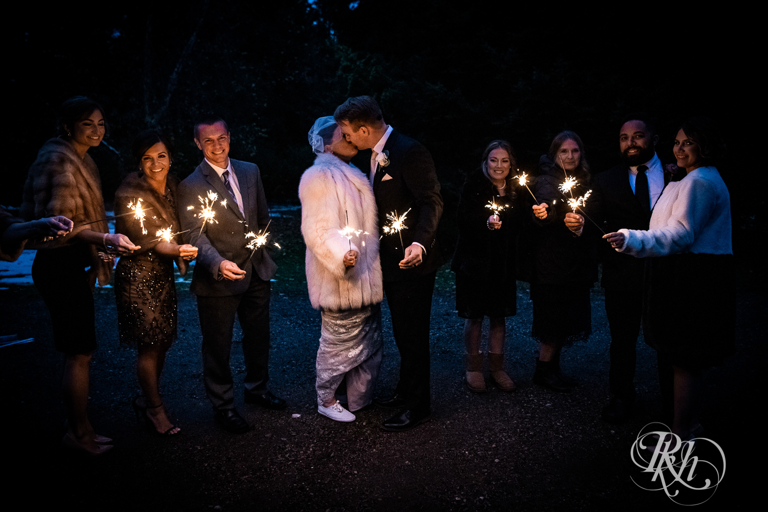 Bride and groom hold sparklers at wedding in cabin in Stillwater, Minnesota.