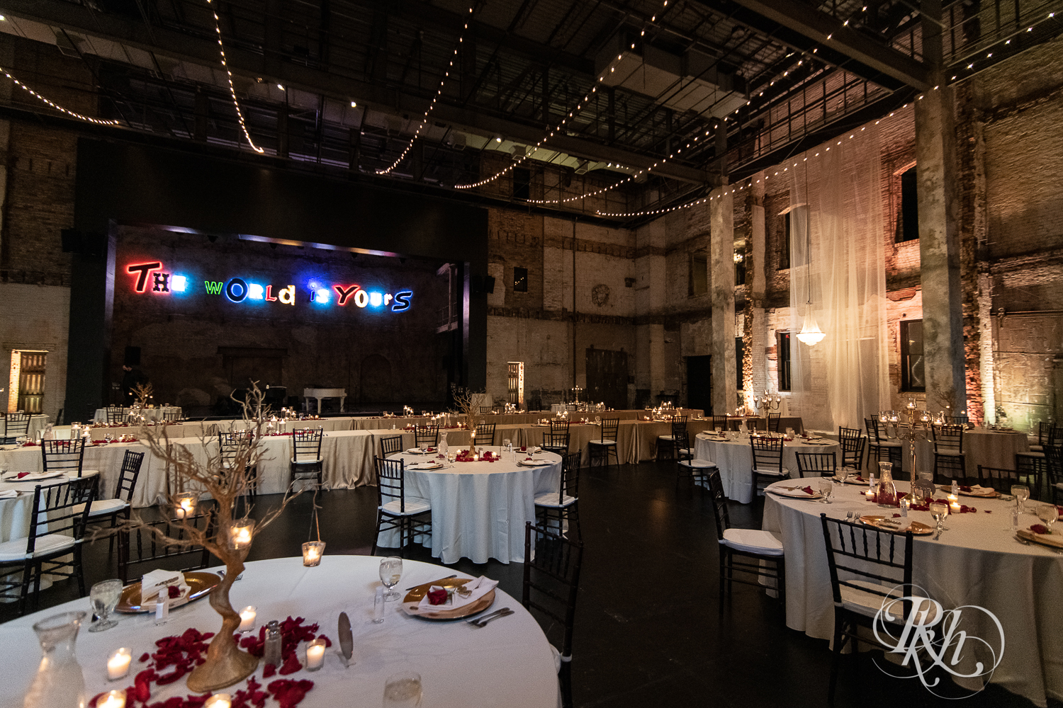 Indoor wedding reception with red accents at Aria in Minneapolis, Minnesota.