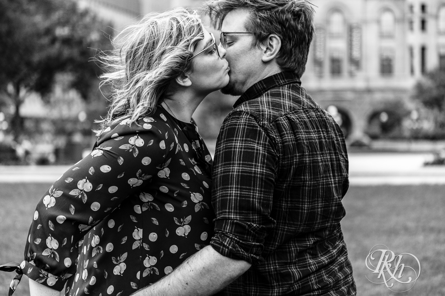 Blond woman with glasses and man with glasses kiss in Saint Paul, Minnesota.