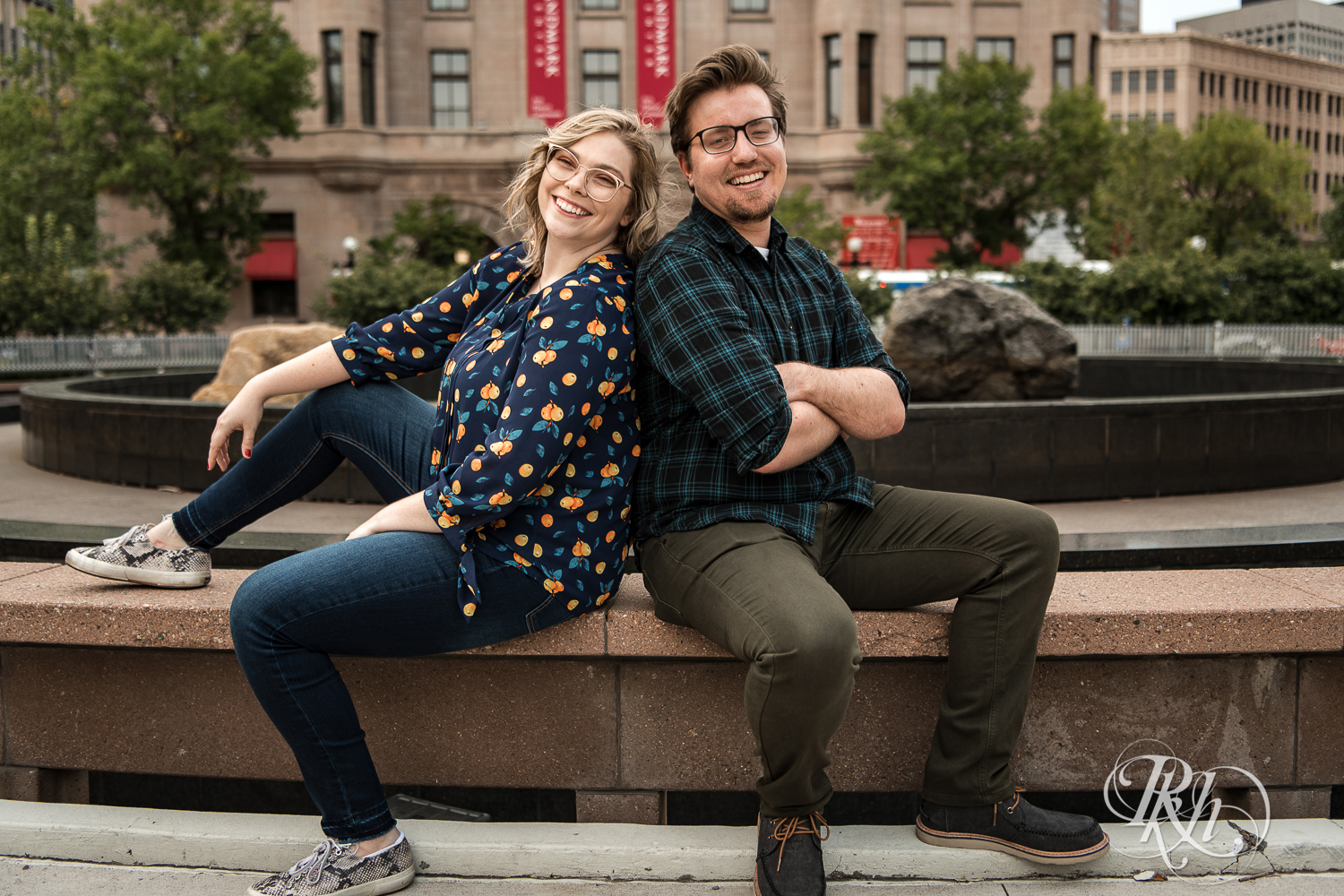 Blond woman with glasses and man with glasses smile in front of Landmark Center in Saint Paul, Minnesota.