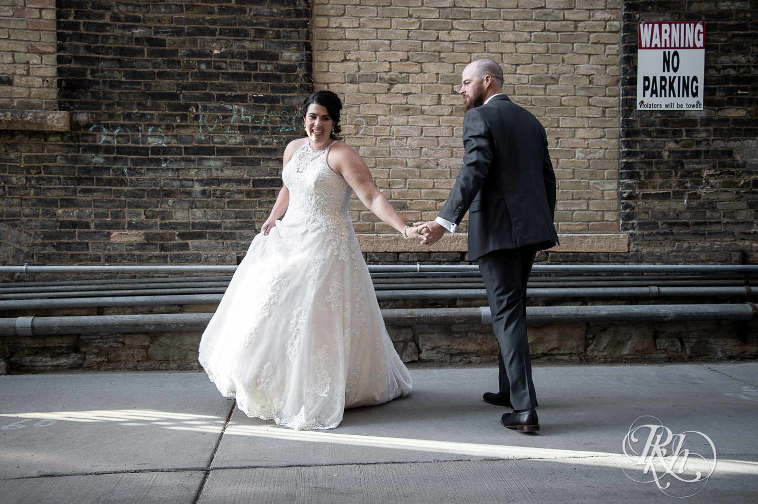 Bride and groom dance in the alley in Saint Anthony Main in Minneapolis, Minnesota.
