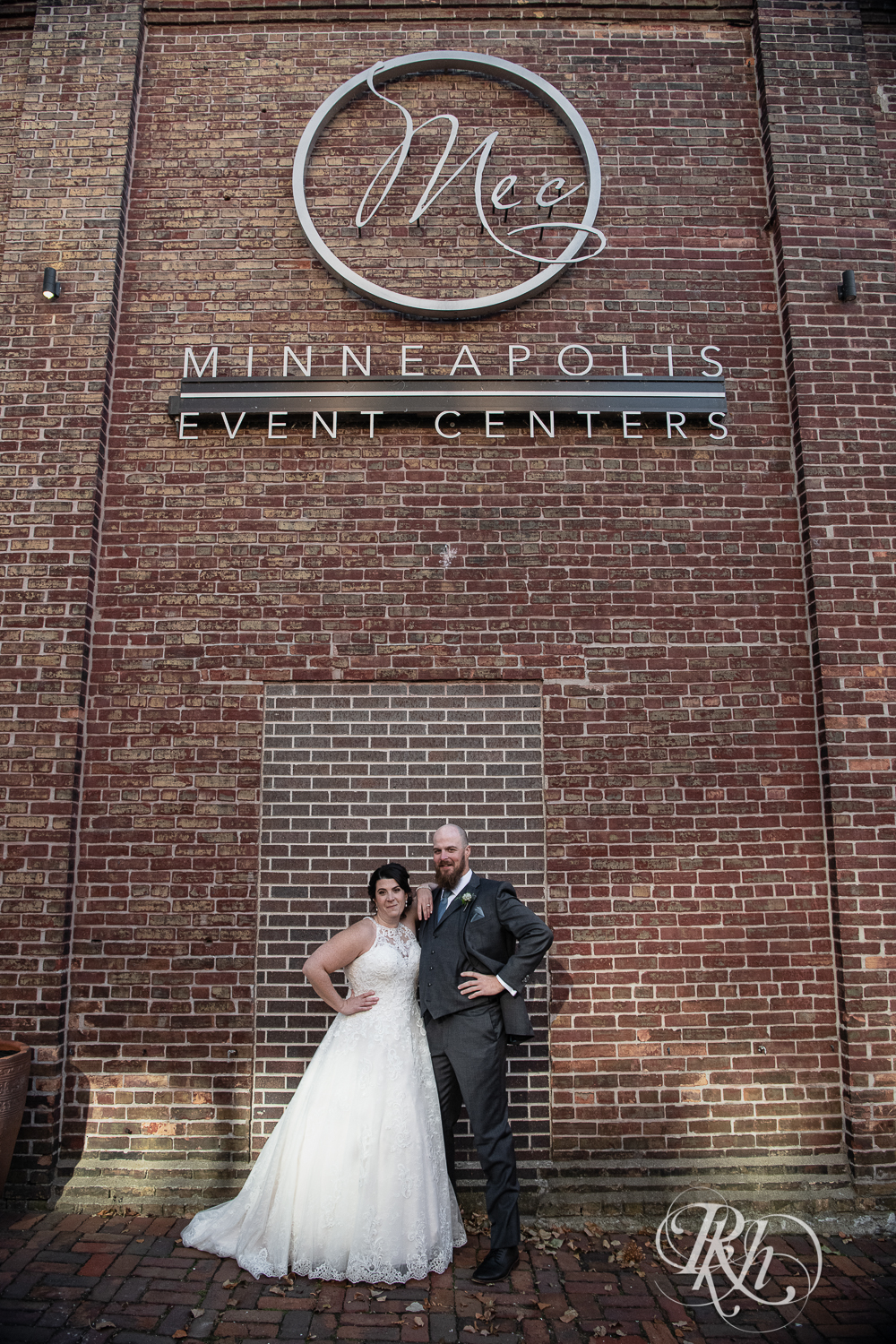 Bride and groom kiss in front of Minneapolis Event Centers in Minneapolis, Minnesota.