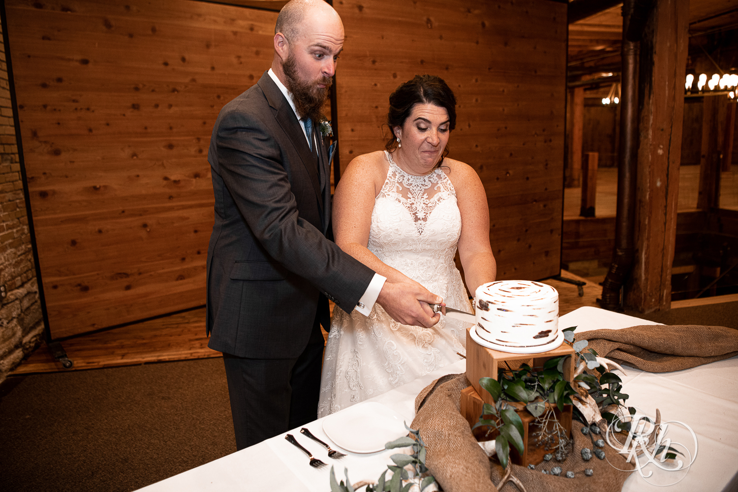 Bride and groom cut wedding cake at Minneapolis Event Centers in Minneapolis, Minnesota.