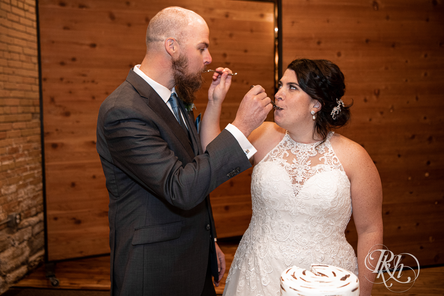 Bride and groom eat wedding cake at Minneapolis Event Centers in Minneapolis, Minnesota.