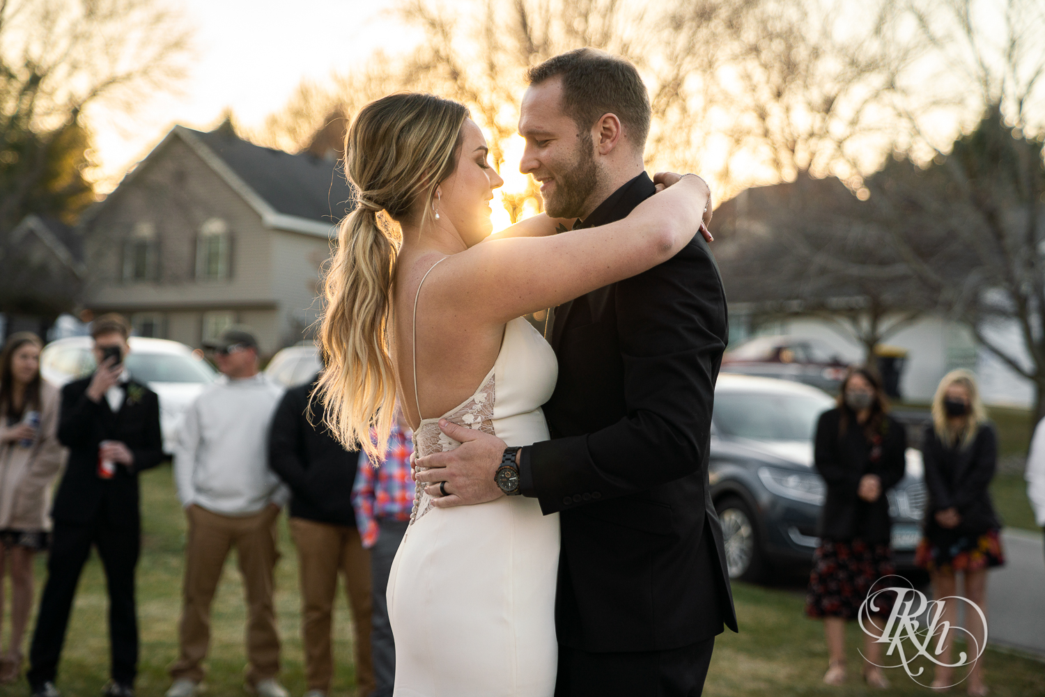 Bride and groom share first dance during sunset in their driveway in Eagan, Minnesota.