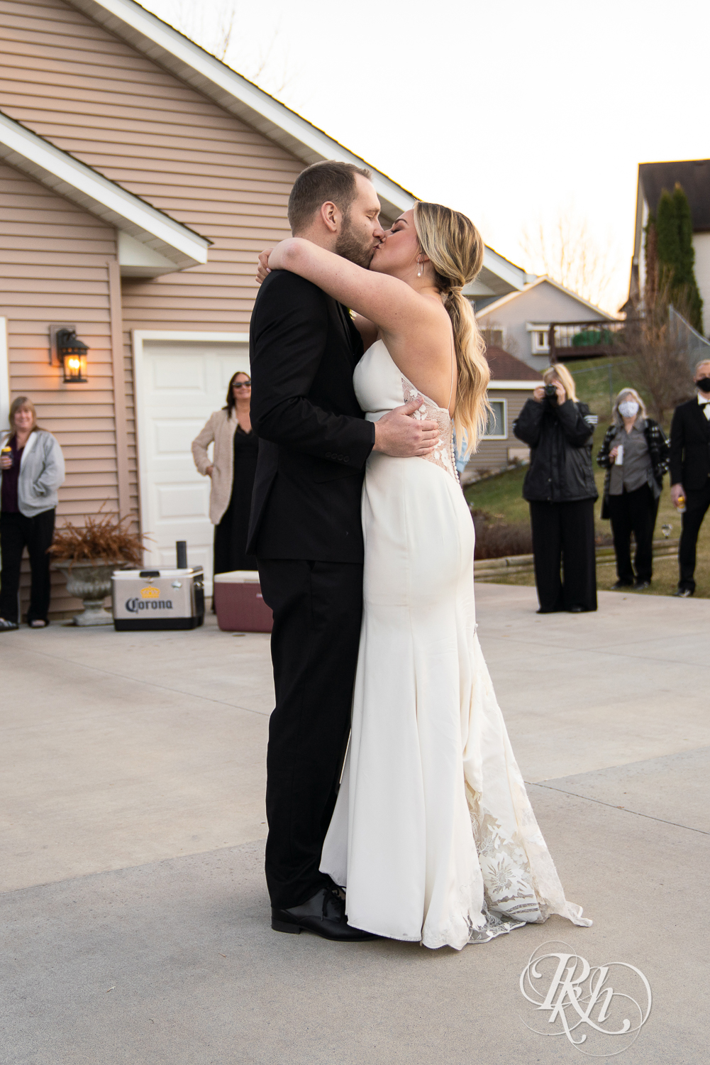Bride and groom share first dance during sunset in their driveway in Eagan, Minnesota.