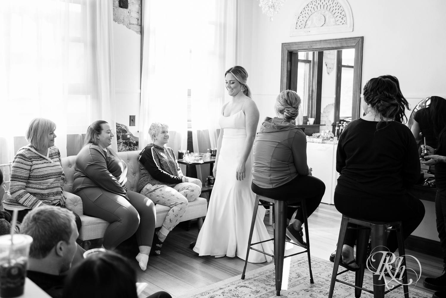 Bride having first look with wedding party and family at the 3 Ten Event Center in Faribault, Minnesota.