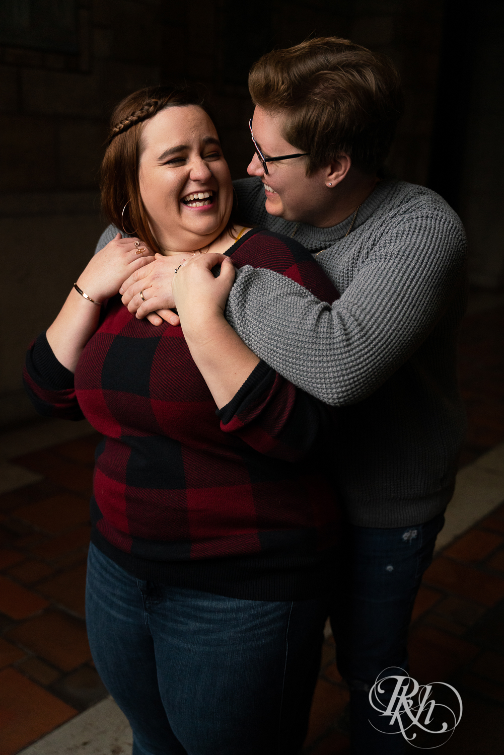 Lesbian couple kiss and laugh in Saint Catherine's in Saint Paul, Minnesota. 