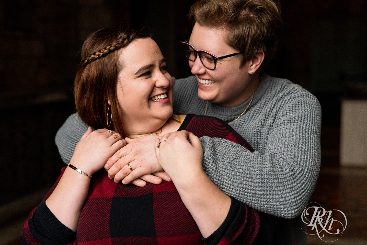 Lesbian couple kiss and laugh in Saint Catherine's in Saint Paul, Minnesota. 
