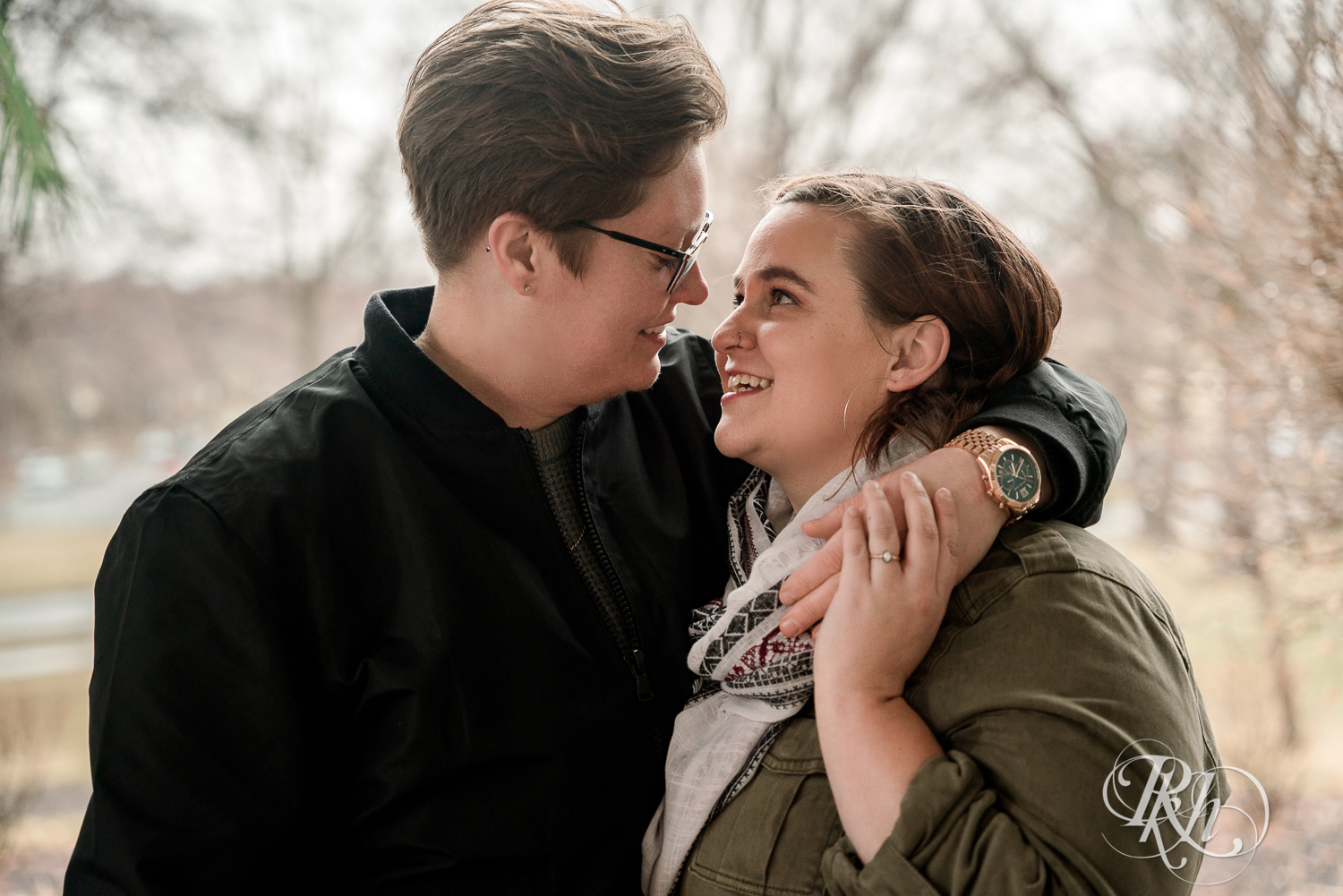 Lesbian couple smile in rain at Saint Catherine's in Saint Paul, Minnesota. 