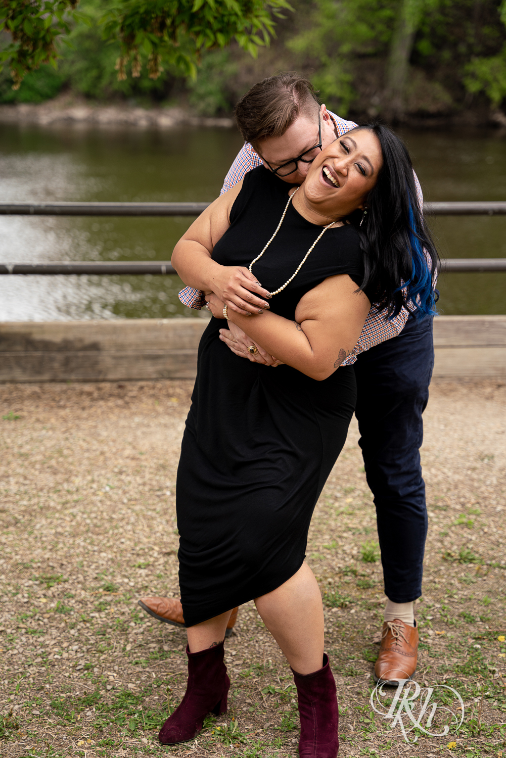 Man and Filipino woman laugh on Nicollet Island in Minneapolis, Minnesota.