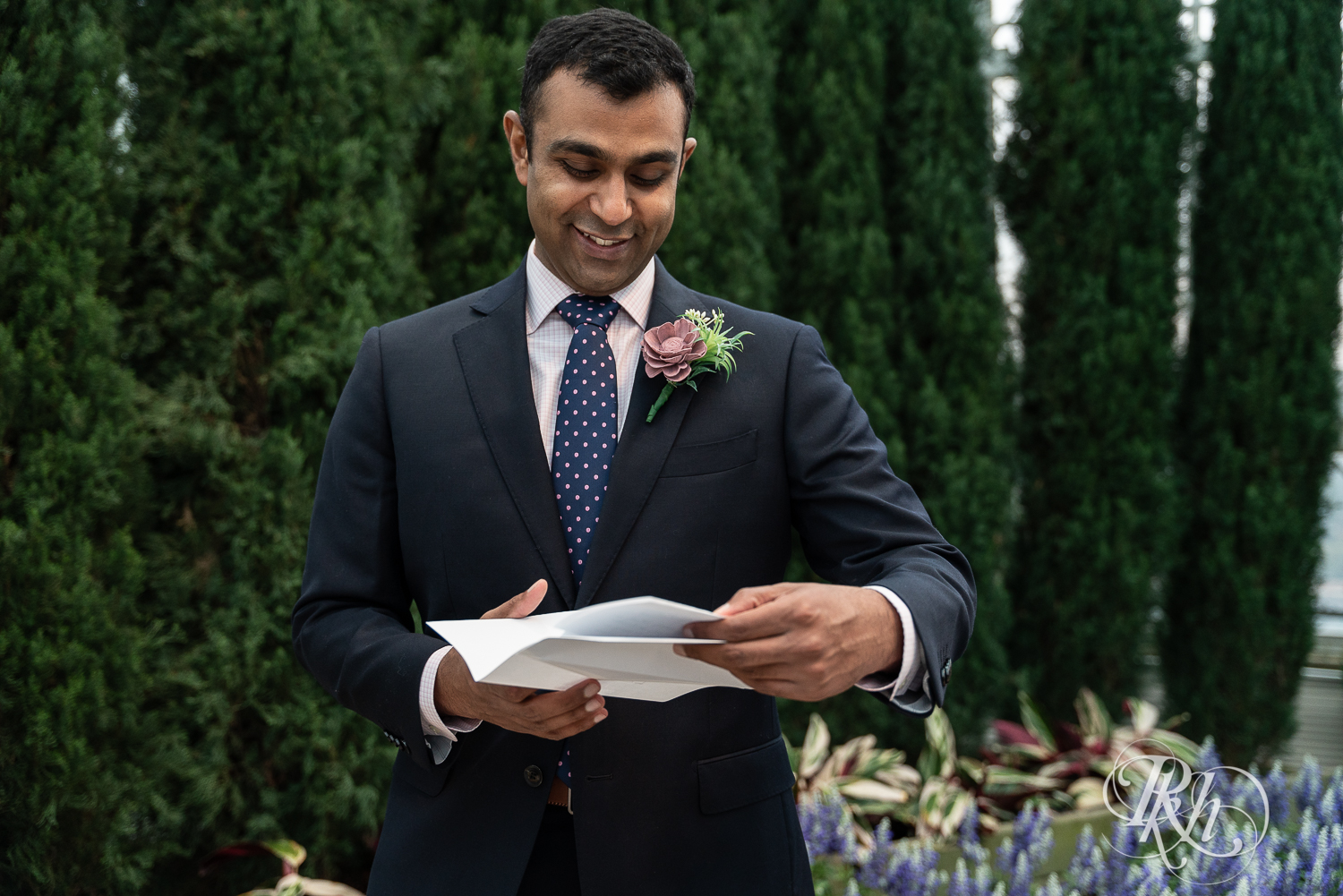 Groom reading vows at Indian wedding at Como Zoo Conservatory in Saint Paul, Minnesota.
