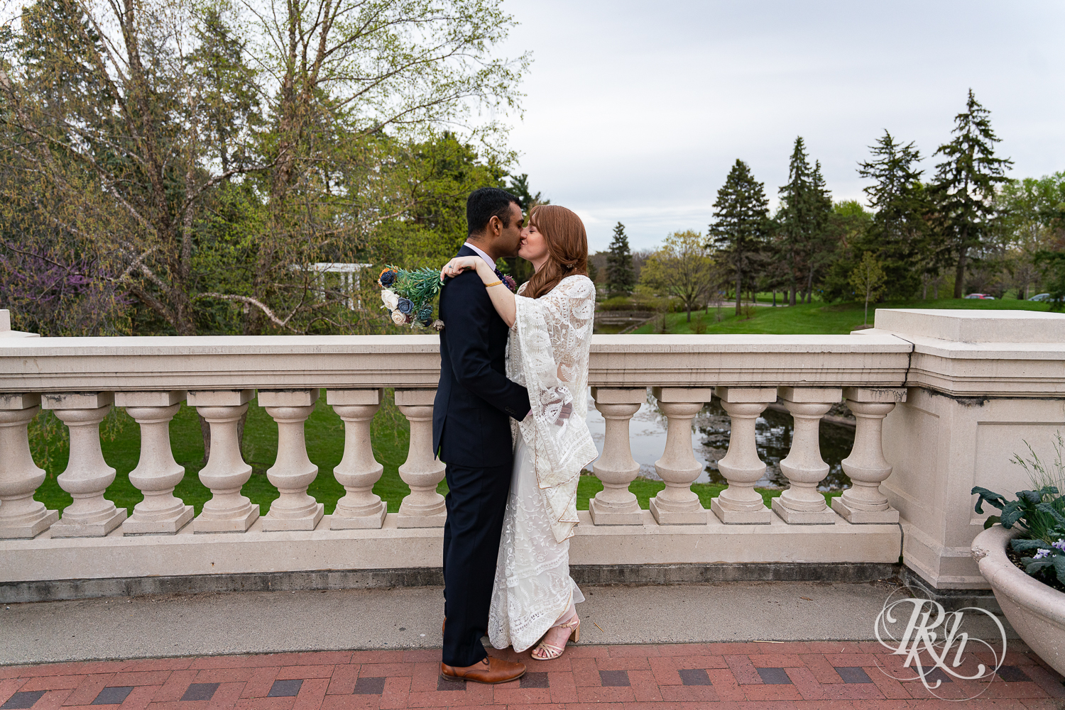 Bride and groom kiss outside at Indian wedding at Como Zoo Conservatory in Saint Paul, Minnesota.