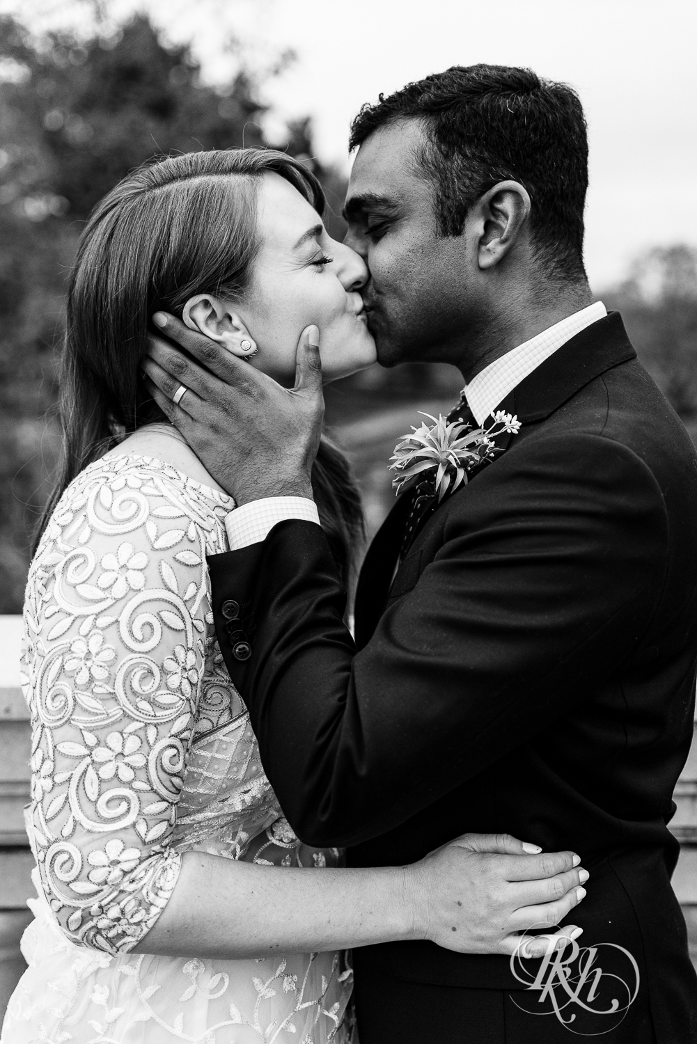 Bride and groom kiss outside at Indian wedding at Como Zoo Conservatory in Saint Paul, Minnesota.