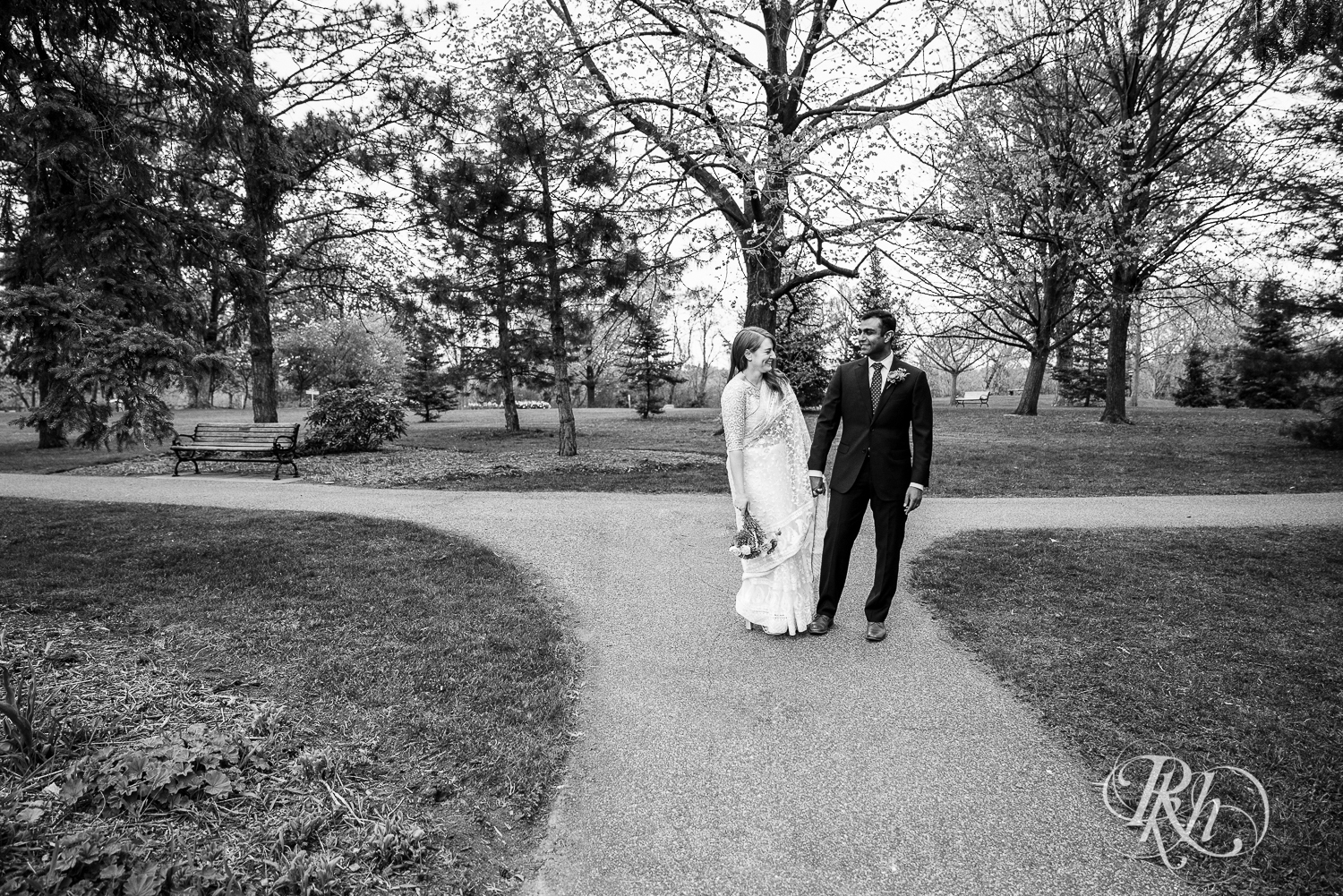 Bride and groom walk outside at Indian wedding at Como Zoo Conservatory in Saint Paul, Minnesota.