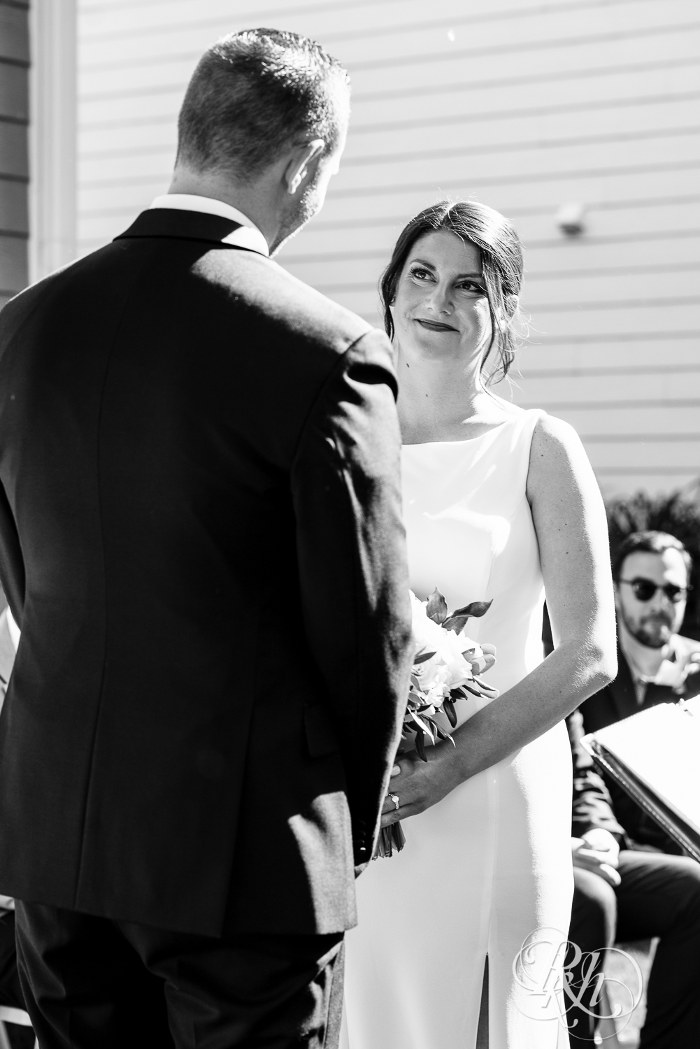 Bride and groom smiling at wedding ceremony at home in Eagan, Minnesota.