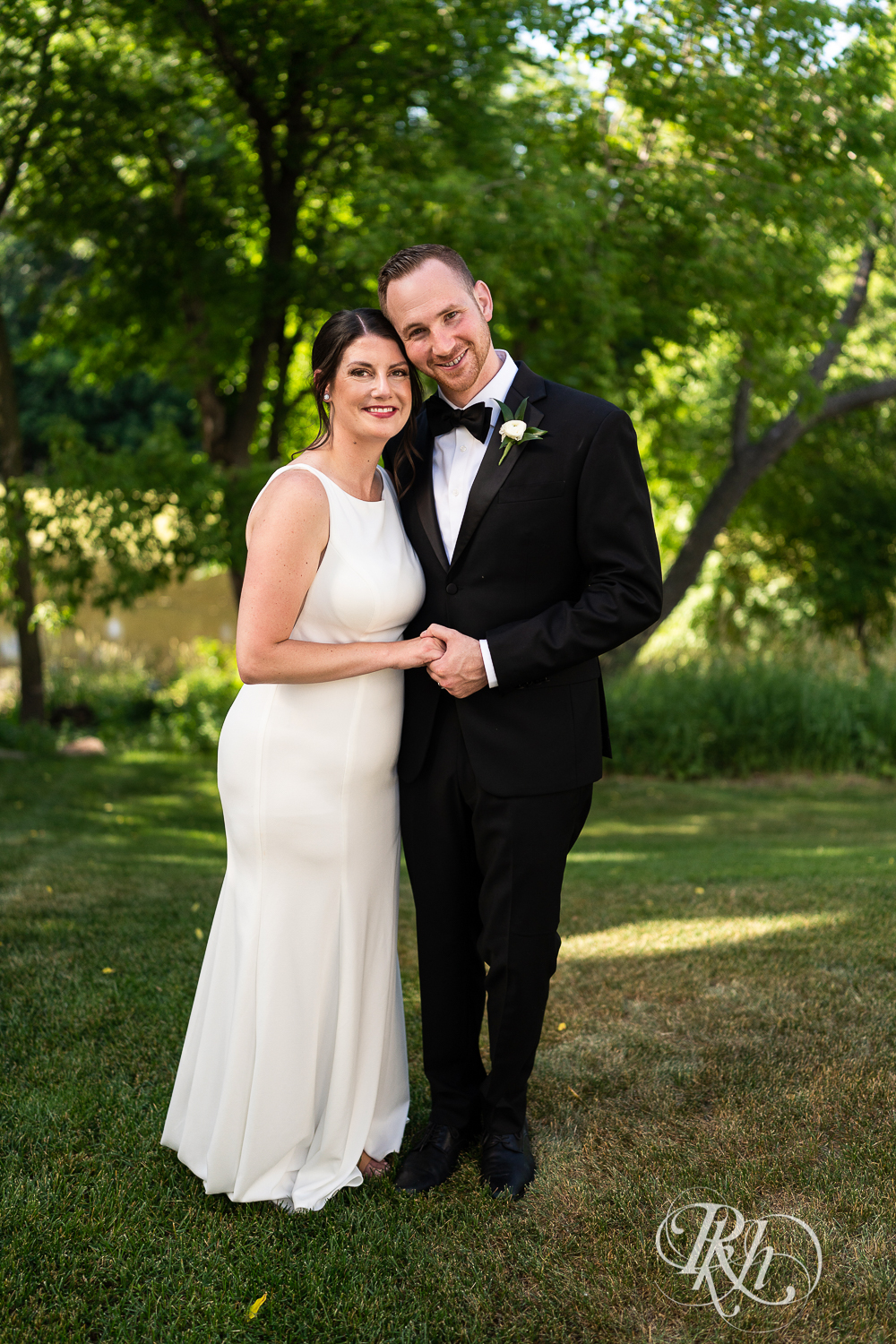 Bride and groom smile at home wedding in Eagan, Minnesota.