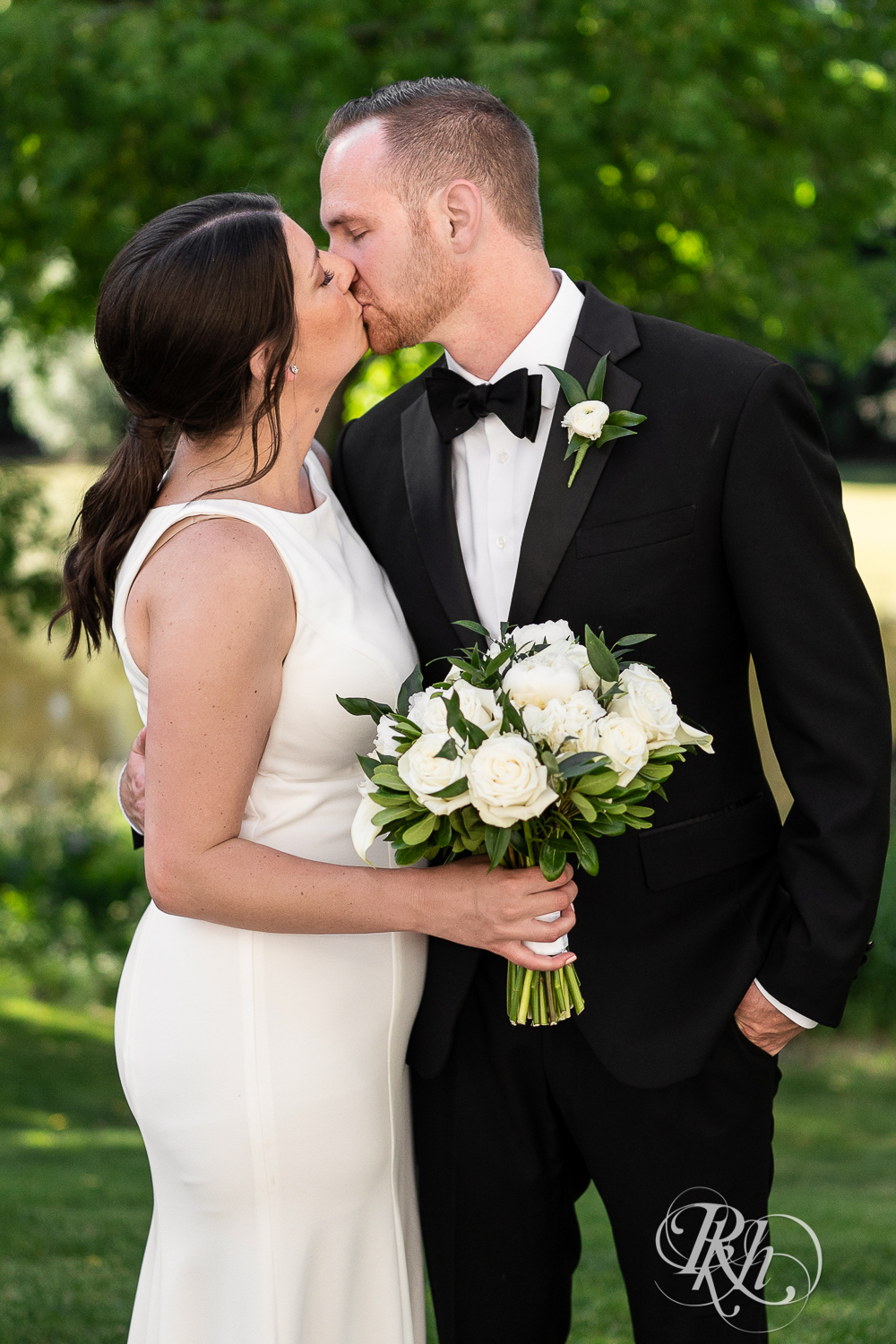 Bride and groom kiss at home wedding in Eagan, Minnesota.