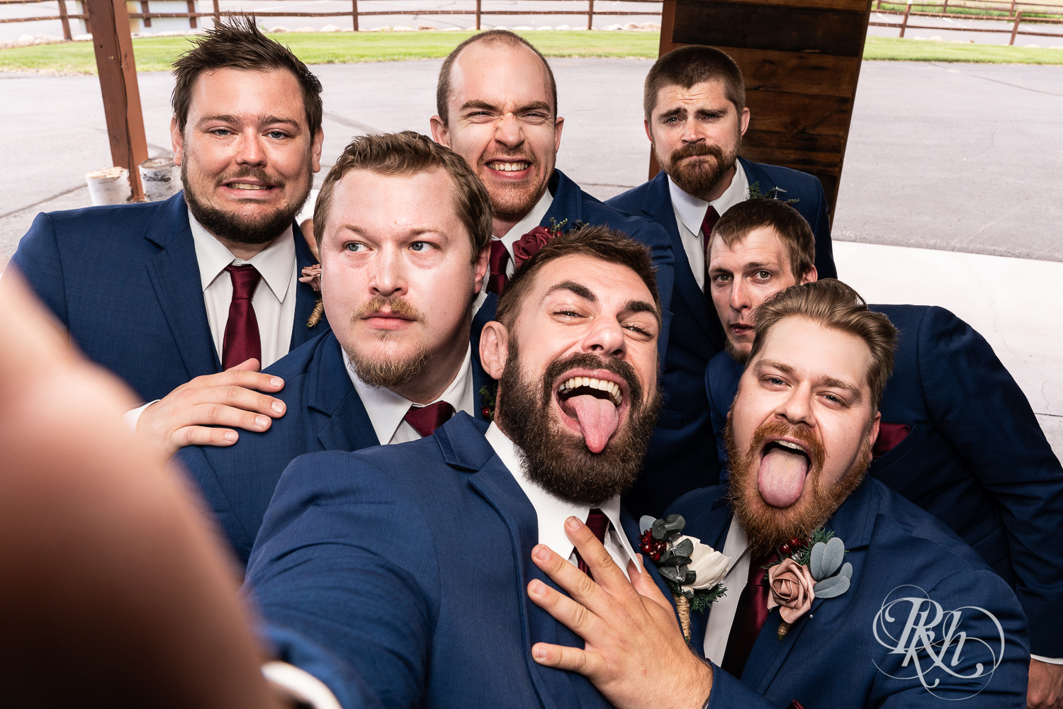 Wedding party in blue suits strike silly poses at Pine Peaks Event Center in Pine River, Minnesota.