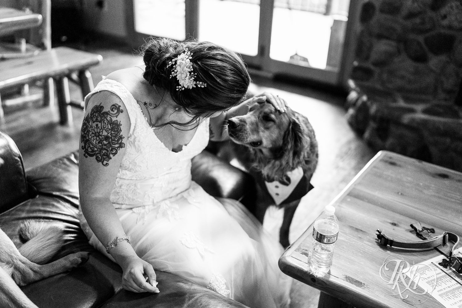 Bride plays with her dog at Pine Peaks Event Center in Pine River, Minnesota.