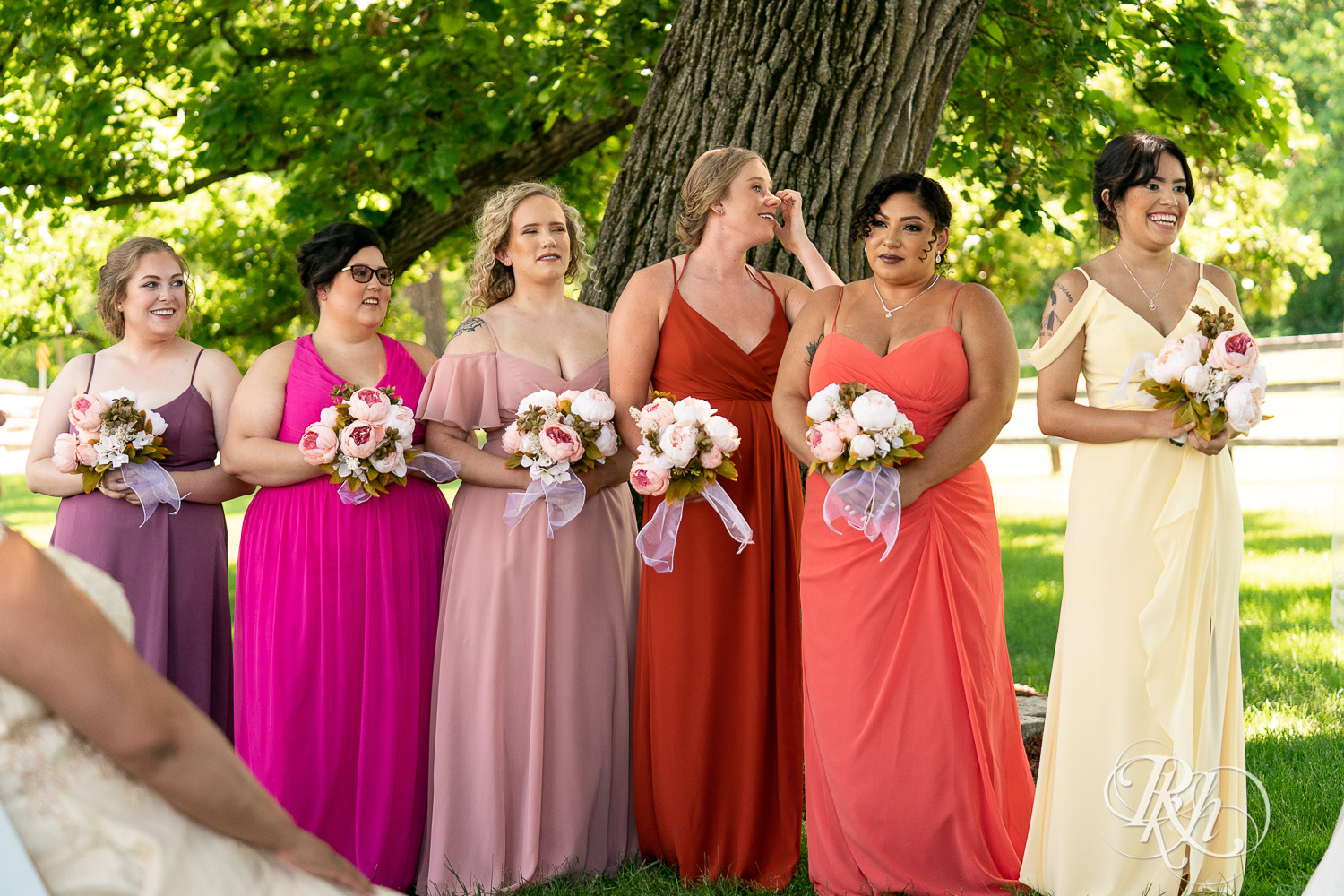 Bridesmaid cry and smile during wedding ceremony at Mayowood Stone Barn in Rochester, Minnesota.