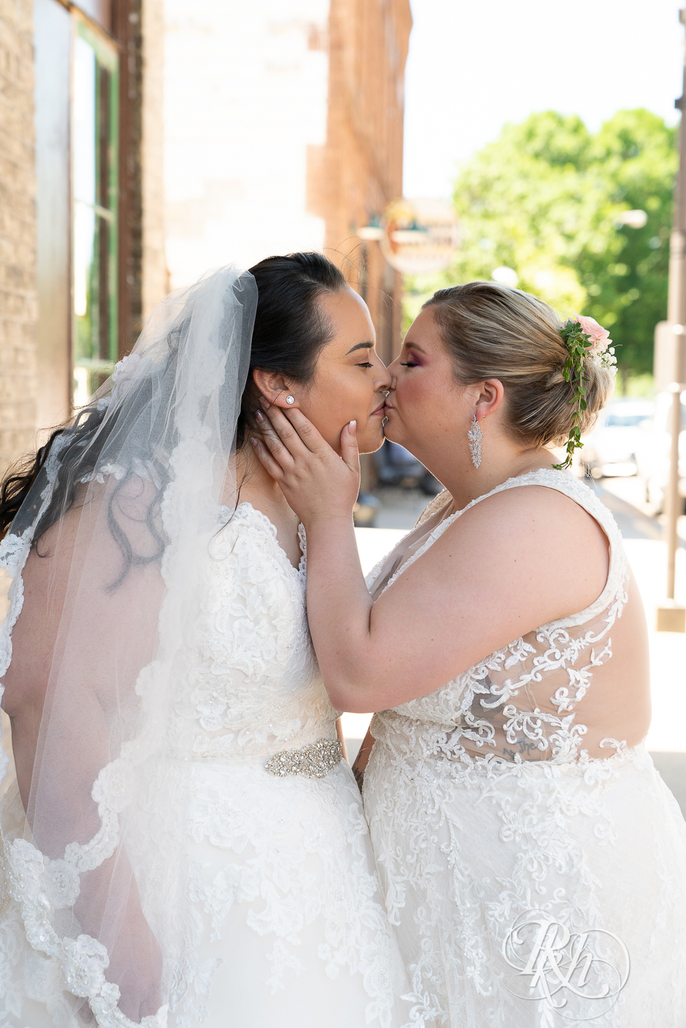 Lesbian brides kiss during wedding day at Cannon River Winery in Cannon Falls, Minnesota.