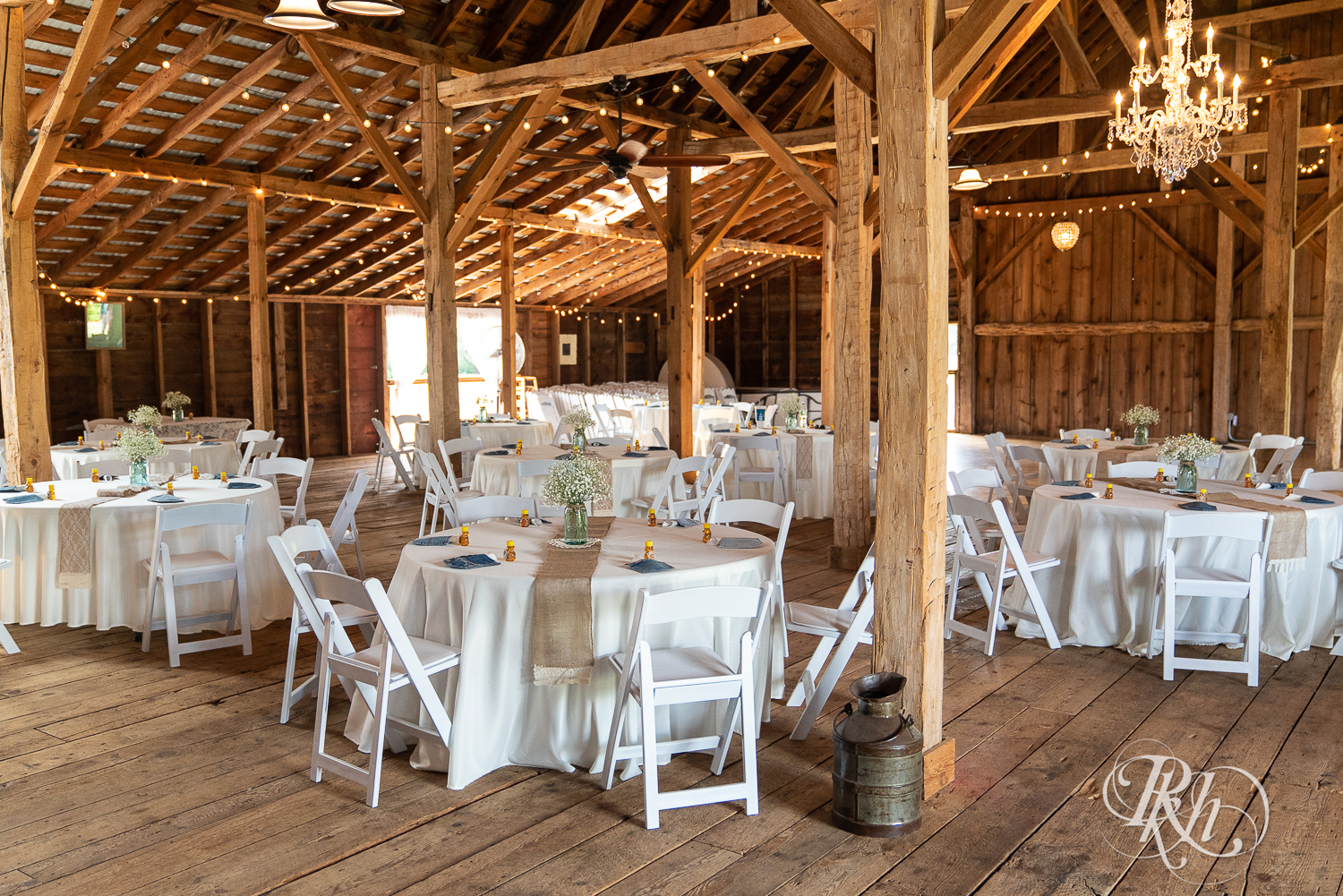 Indoor country barn wedding ceremony setup at Croix View Farm in Osceola, Wisconsin.