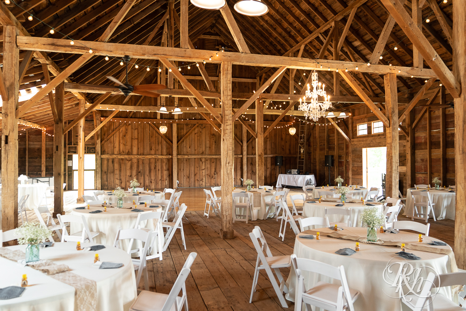 Indoor country barn wedding ceremony setup at Croix View Farm in Osceola, Wisconsin.