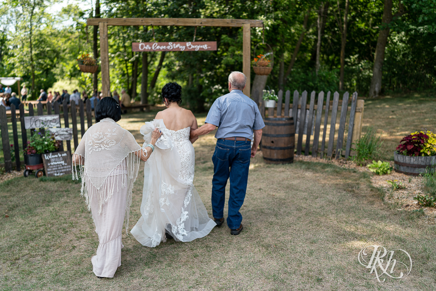 Bride walks down the aisle at wedding ceremony at Croix View Farm in Osceola, Wisconsin.