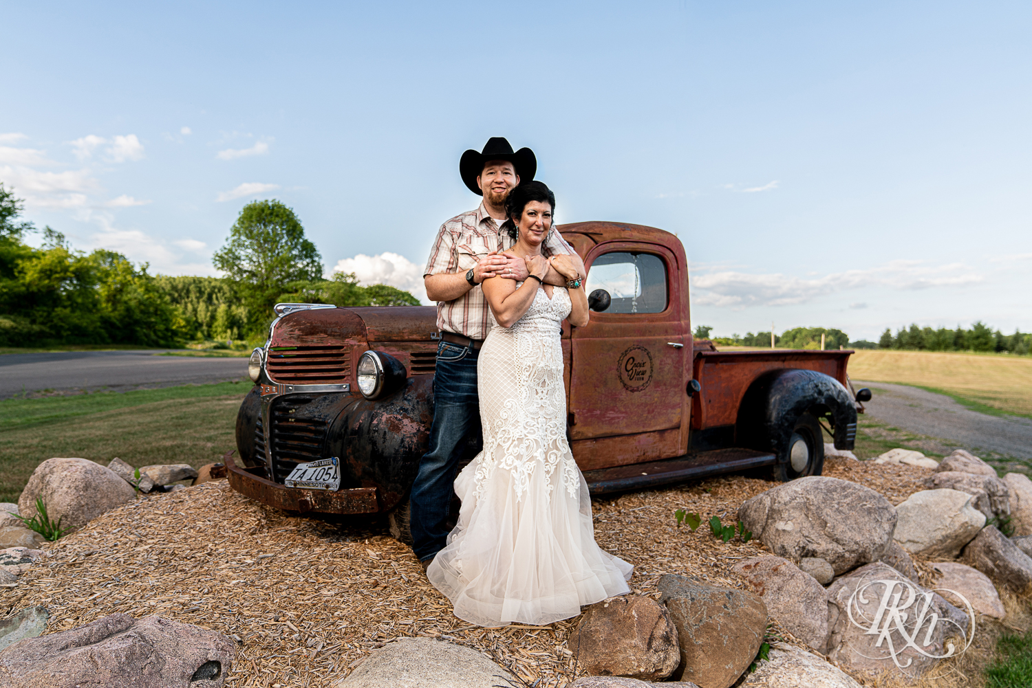 Bride and groom in front of pickup truck either at Croix View Farm in Osceola, Wisconsin.