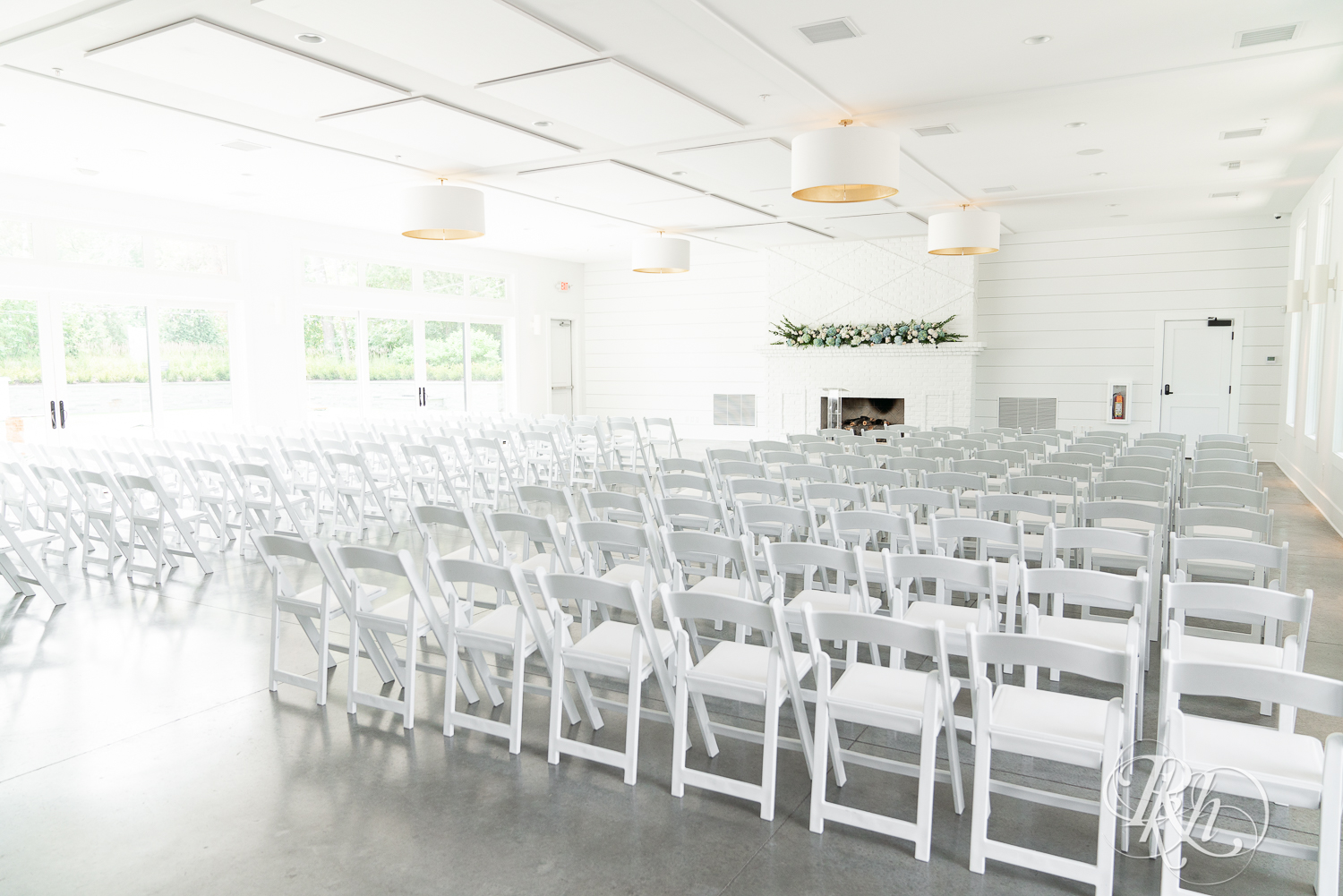 Indoor wedding ceremony setup with blue and white flowers at The Hutton House in Medicine Lake, Minnesota.