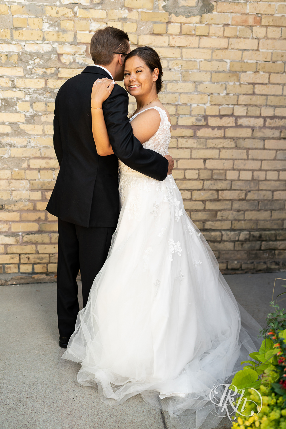 Bride and groom smile at Kellerman's Event Center in White Bear Lake, Minnesota.
