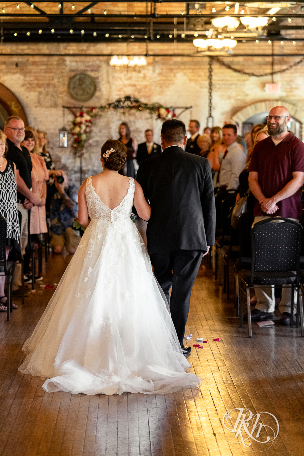 Bride walking down the aisle with her dad during wedding ceremony at Kellerman's Event Center in White Bear Lake, Minnesota.