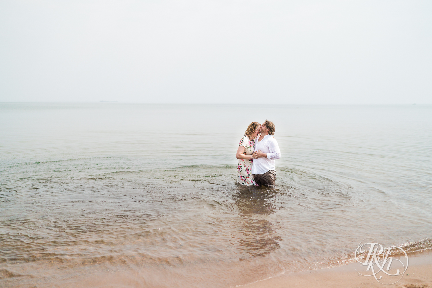 beach engagement session couple in water