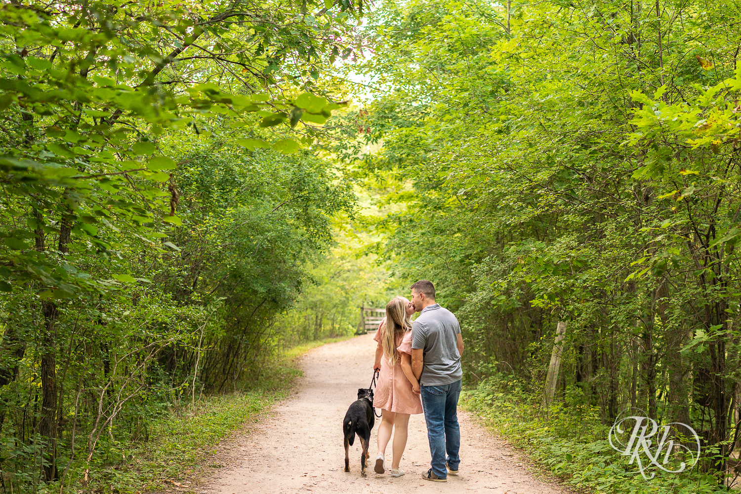 Man and woman walking their Doberman at Afton State Park in Hastings, Minnesota.
