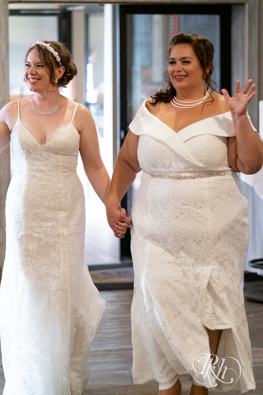 Lesbian brides enter wedding reception at Willy McCoy's in Champlin, Minnesota.