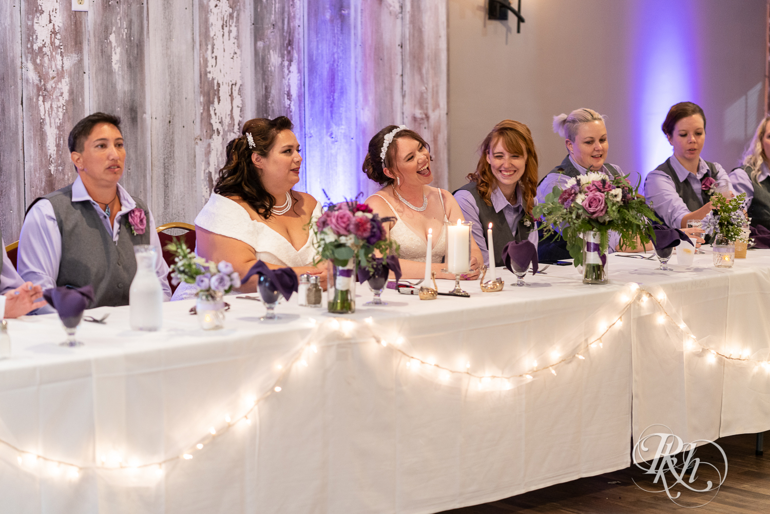 Lesbian brides at head table at wedding reception at Willy McCoy's in Champlin, Minnesota.