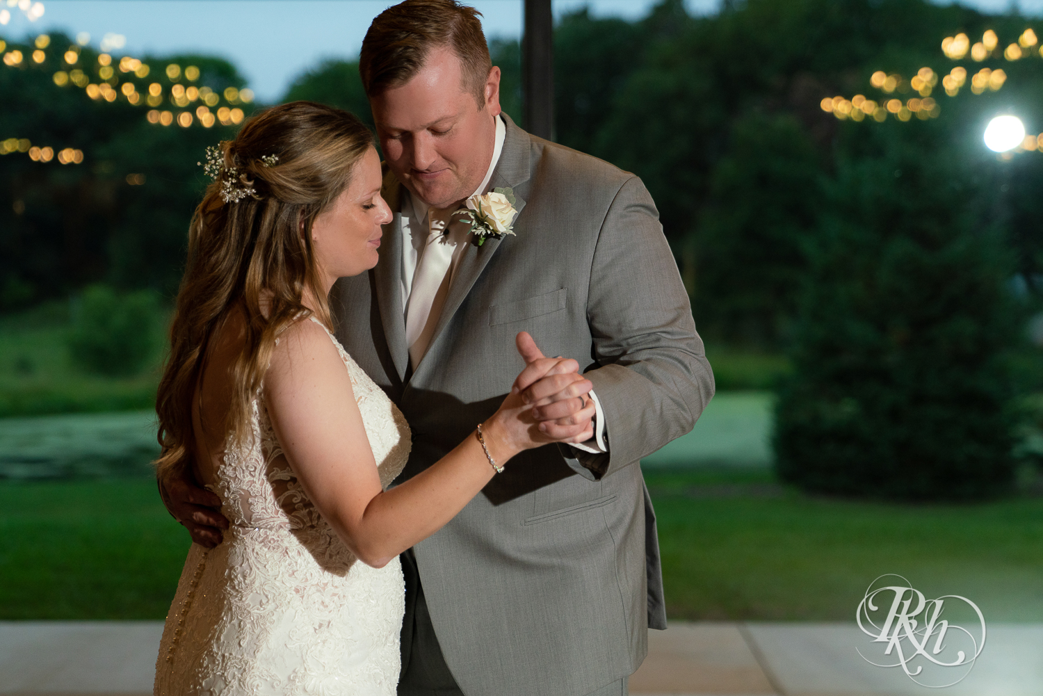 Bride and groom sharing first dance during wedding reception at 7 Vines Vineyard in Dellwood, Minnesota.