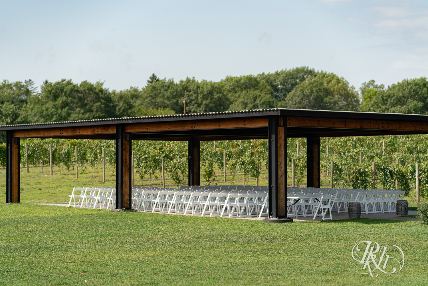 Outdoor summer wedding ceremony setup at 7 Vines Vineyard in Dellwood, Minnesota.