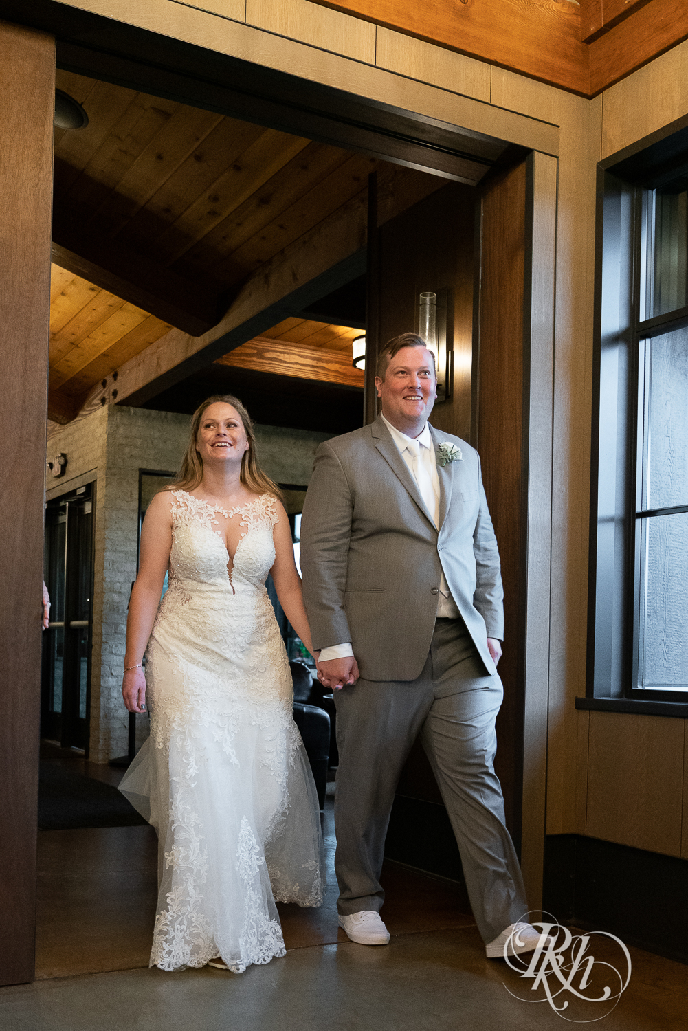 Bride and groom doing grand entrance for wedding reception at 7 Vines Vineyard in Dellwood, Minnesota.