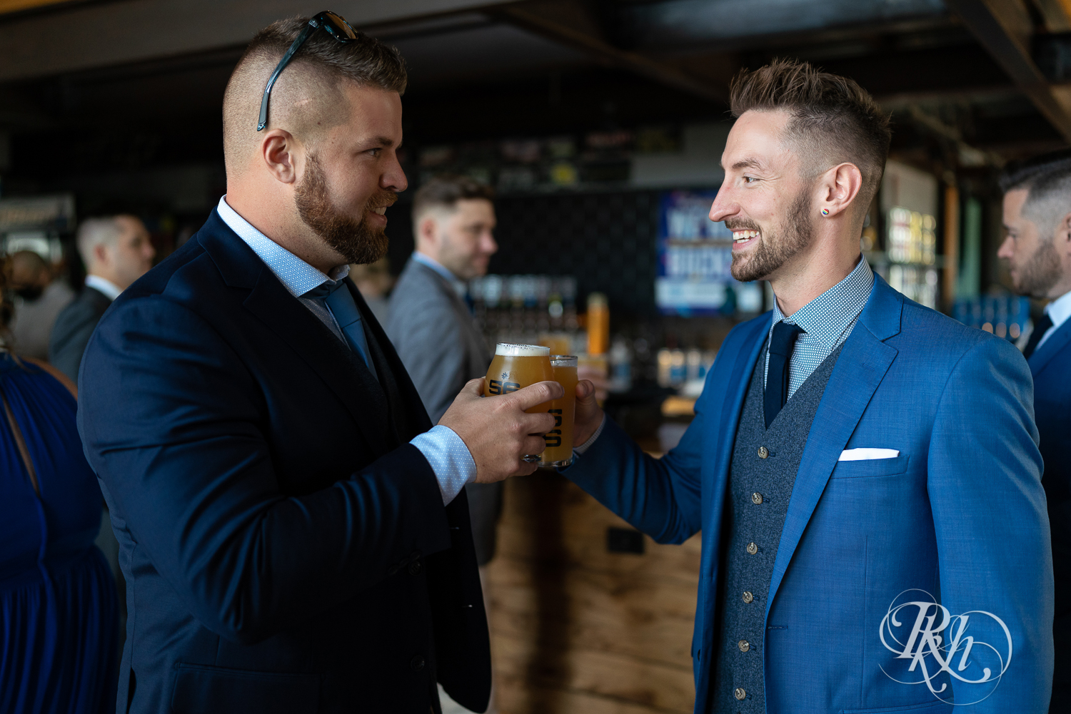 Gay grooms getting toasting drinks before wedding in Minneapolis, Minnesota.