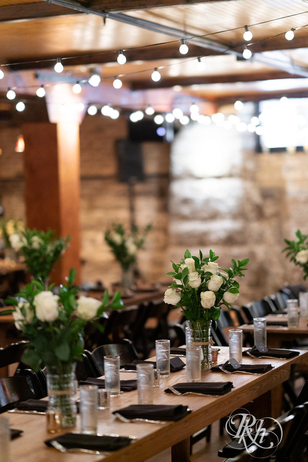 Indoor reception setup with candles and flowers in Hall of Kings in Minneapolis, Minnesota.